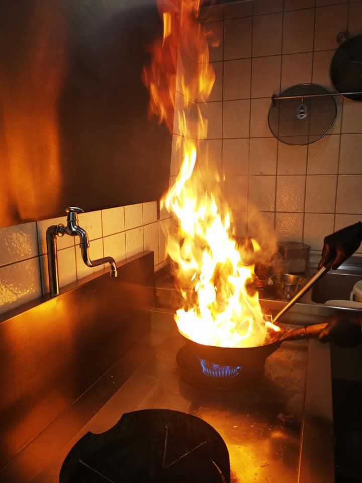 Flames rising from the wok