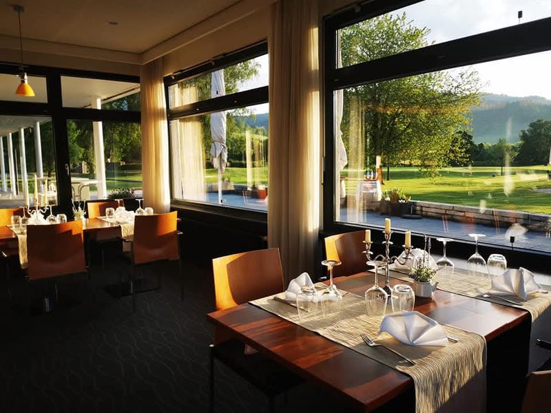 Bright dining room with large windows facing the golf course